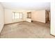A spacious living room with neutral carpet and a large window for natural light at 9010 Deer Run Dr, Indianapolis, IN 46256