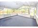 Enclosed porch with lots of windows and natural light, with a swing for relaxation at 9010 Deer Run Dr, Indianapolis, IN 46256