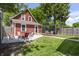 Wide shot of a backyard featuring a patio area, some chairs, a fire pit with chairs, and grass at 941 N Beville Ave, Indianapolis, IN 46201