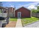 Backyard featuring a detached garage, a patio area, some chairs, and grass at 941 N Beville Ave, Indianapolis, IN 46201