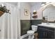 Bathroom with a shower and toilet, and a black vanity with a white sink at 941 N Beville Ave, Indianapolis, IN 46201