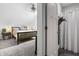Bathroom with a view into the bedroom featuring a shower, and a door at 941 N Beville Ave, Indianapolis, IN 46201