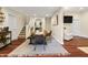 An open dining room with hardwood floors next to staircase and living area at 941 N Beville Ave, Indianapolis, IN 46201