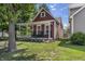 Charming home featuring a cozy front porch with rocking chairs and landscaped yard at 941 N Beville Ave, Indianapolis, IN 46201