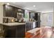 Modern kitchen featuring dark cabinets, stainless steel appliances, and hardwood floors at 941 N Beville Ave, Indianapolis, IN 46201