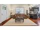 Cozy living room with hardwood floors, a comfortable leather couch, and ample natural light at 941 N Beville Ave, Indianapolis, IN 46201