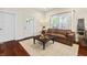 Bright living room featuring hardwood floors, a leather couch, and modern décor at 941 N Beville Ave, Indianapolis, IN 46201