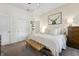 Bright and airy bedroom featuring neutral tones, plush carpet, and access to the ensuite bathroom at 941 N Beville Ave, Indianapolis, IN 46201
