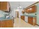 Functional kitchen featuring wood cabinetry and white appliances, offering a practical and efficient layout at 959 Harvest Ridge Dr, Avon, IN 46123