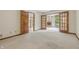 Living room with glass doors leading to a sunroom, showcasing seamless transition and bright views of the exterior at 959 Harvest Ridge Dr, Avon, IN 46123
