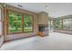 Bright living room featuring a corner fireplace and large windows offering views of the outdoor greenery at 959 Harvest Ridge Dr, Avon, IN 46123