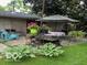 Charming backyard patio with seating, a table and landscaping at 9701 Hamilton Hills Ln, Fishers, IN 46038
