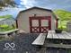This barn is surrounded by dark mulch with a picnic table nearby at 9701 Hamilton Hills Ln, Fishers, IN 46038