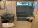 Bathroom featuring retro blue fixtures, tile floor, and patterned glass window at 9701 Hamilton Hills Ln, Fishers, IN 46038