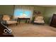 Well-lit bedroom with comfortable seating, a side table, and a large window at 9701 Hamilton Hills Ln, Fishers, IN 46038