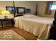 Comfortable bedroom featuring a four-poster bed, hardwood floors, and natural lighting at 9701 Hamilton Hills Ln, Fishers, IN 46038