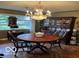 Charming dining room featuring a decorative chandelier and classic hardwood flooring at 9701 Hamilton Hills Ln, Fishers, IN 46038