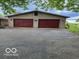 Spacious garage with a large paved driveway and a neutral-colored exterior at 9701 Hamilton Hills Ln, Fishers, IN 46038