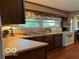 Traditional kitchen featuring wood cabinets, laminate countertops and a double basin sink at 9701 Hamilton Hills Ln, Fishers, IN 46038