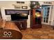 Cozy living room featuring hardwood floors, and built-in cabinets at 9701 Hamilton Hills Ln, Fishers, IN 46038