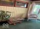 Bright living room with paneled walls, rustic furniture, and a view of the outdoors at 9701 Hamilton Hills Ln, Fishers, IN 46038