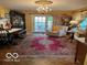 Bright living room with hardwood floors, a chandelier, and french doors leading to the outdoors at 9701 Hamilton Hills Ln, Fishers, IN 46038