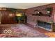 Cozy living area with brick fireplace, hardwood floors, and traditional decor at 9701 Hamilton Hills Ln, Fishers, IN 46038