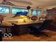 Spacious office with a large desk, built-in shelving, and natural light at 9701 Hamilton Hills Ln, Fishers, IN 46038
