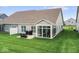 View of the home's backyard, patio, and screened-in porch at 104 Perlican Dr, Cicero, IN 46034