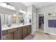 Bathroom with double vanity, shaker cabinets, framed mirrors and an adjoining closet space at 104 Perlican Dr, Cicero, IN 46034