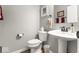 Powder room with pedestal sink, toilet, and decorated with framed pictures at 104 Perlican Dr, Cicero, IN 46034