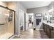 Bathroom with double vanity, tile shower with black frame, and adjoining bedroom at 104 Perlican Dr, Cicero, IN 46034