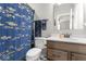Bathroom with blue fish shower curtain, toilet, and single sink vanity at 104 Perlican Dr, Cicero, IN 46034