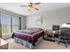 Bedroom featuring a ceiling fan, large window, and work space with desk and rolling chair at 104 Perlican Dr, Cicero, IN 46034