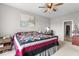 Bedroom featuring a ceiling fan, neutral wall color, and a bed with colorful quilt at 104 Perlican Dr, Cicero, IN 46034