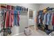 Walk-in closet featuring ample shelving, hanging racks, and views of the laundry room at 104 Perlican Dr, Cicero, IN 46034