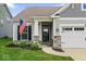 Inviting front porch and well-manicured lawn enhance this home's curb appeal at 104 Perlican Dr, Cicero, IN 46034