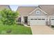 Charming home exterior with a well-manicured lawn and a two-car garage at 104 Perlican Dr, Cicero, IN 46034