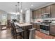 Modern kitchen with stainless steel appliances, a large island, and ample counter space at 104 Perlican Dr, Cicero, IN 46034