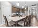 Bright kitchen showcases a large island with seating, wooden cabinets, stainless appliances, and modern pendant lighting at 104 Perlican Dr, Cicero, IN 46034