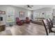 Spacious living room with hardwood floors, ceiling fan, and a cozy seating area at 104 Perlican Dr, Cicero, IN 46034