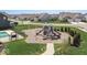 Community playground with swings, slides, and a pool area, perfect for Gathering recreation at 104 Perlican Dr, Cicero, IN 46034