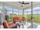 Bright sunroom with comfortable seating and views of the expansive backyard at 104 Perlican Dr, Cicero, IN 46034