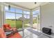 Enclosed porch with seating and sliding door to a backyard at 104 Perlican Dr, Cicero, IN 46034