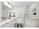 Modern bathroom features double vanity, glass shower, and decorative floor tiles at 10479 Dusty Rose Dr, Zionsville, IN 46077