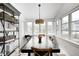 Bright dining room features large windows, table with seating for six, and modern decor at 10479 Dusty Rose Dr, Zionsville, IN 46077