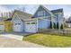 Charming two-story home featuring a two-car garage, a well-manicured lawn, and a quaint wooden fence at 10479 Dusty Rose Dr, Zionsville, IN 46077