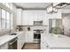Well-appointed kitchen featuring stainless steel appliances, white cabinets, and a stylish backsplash at 10479 Dusty Rose Dr, Zionsville, IN 46077
