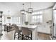 Bright kitchen with white cabinetry, stainless steel appliances, and a cozy breakfast bar at 10479 Dusty Rose Dr, Zionsville, IN 46077