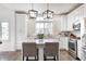 Modern kitchen with stainless steel appliances, white cabinets, and a center island with bar seating at 10479 Dusty Rose Dr, Zionsville, IN 46077